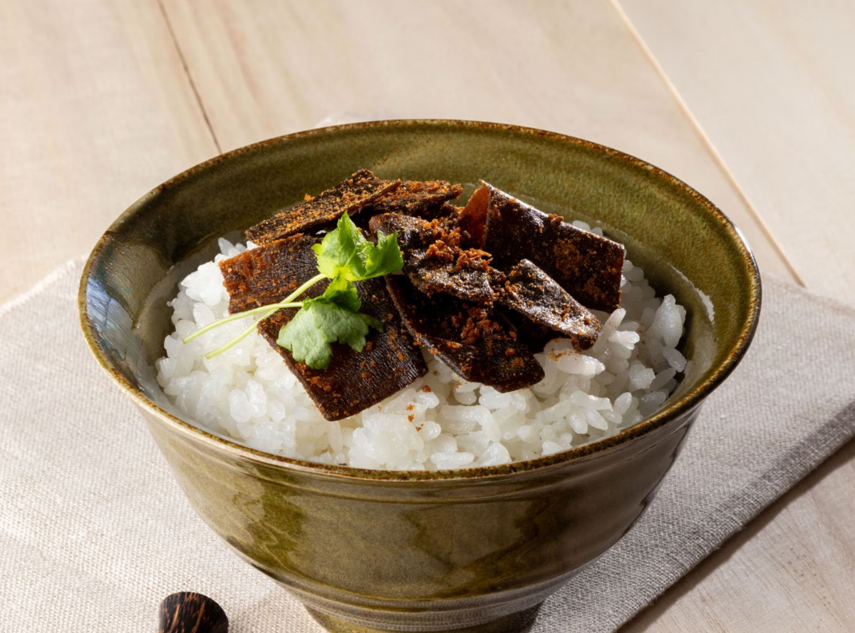 Bonito and kelp tsukudani rice topping served over steamed white rice in a ceramic bowl