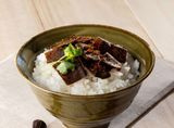 Bonito and kelp tsukudani rice topping served over steamed white rice in a ceramic bowl
